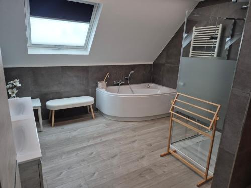 a bathroom with a bath tub and a sink at Sweet&City HOUSE in Saint-Vith