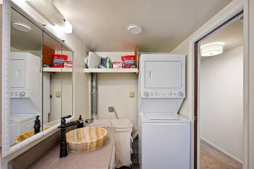 a small laundry room with a washer and dryer at Seatac Lake Cottage A2 in SeaTac