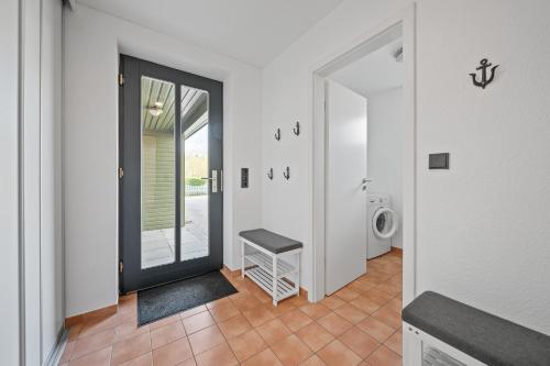 a hallway with a door leading to a laundry room at Dünenhus Appartement Dünenhus in Böhl