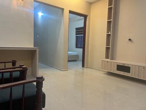 a hallway with a mirror and a room with a bed at S S Apartment in Kannur