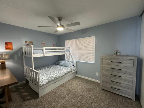 a childs bedroom with a bunk bed and a dresser at Surfer's Bungalow in San Diego