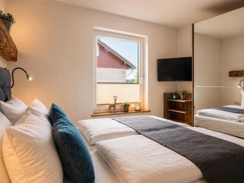 a bedroom with two beds and a window at MiraBlau Braunlage in Braunlage