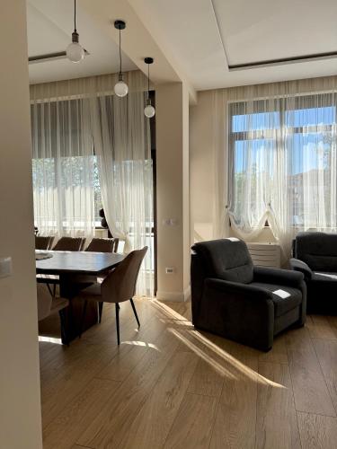 a living room with a black couch and a table at Easy Stay in Karlovo