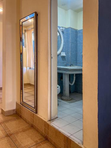 a bathroom with a mirror and a sink at Casa Piedra Parada in Brisas de Zicatela