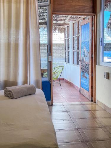 a bedroom with a bed with a towel on it at Casa Piedra Parada in Brisas de Zicatela