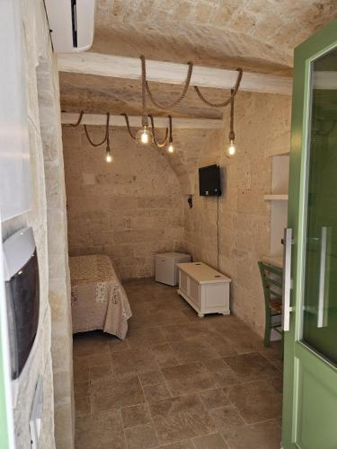 a small room with a bed and a tv in it at Stanza29 in Martina Franca