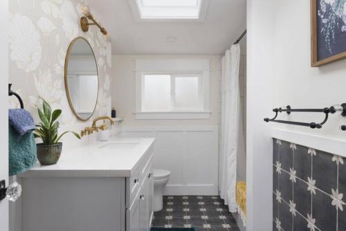 a bathroom with a sink and a toilet and a mirror at Charming Home Downtown Paso Robles in Paso Robles