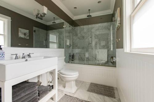 a bathroom with a sink and a toilet and a shower at Iconic Modern Farmhouse in San Luis Obispo