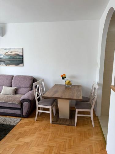 a living room with a table and a couch at Apartment Varezić in Plužine