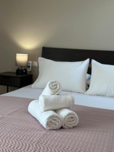 a pile of towels sitting on top of a bed at Kaloula's home in Keramoto