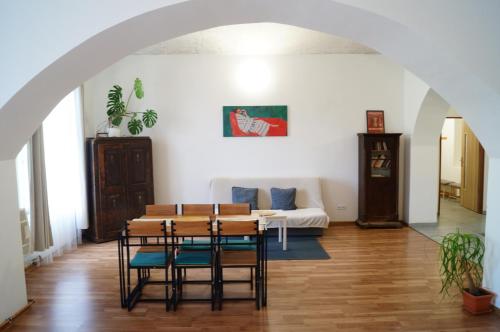 a living room with a table and a couch at Apartment Porta in Terezín