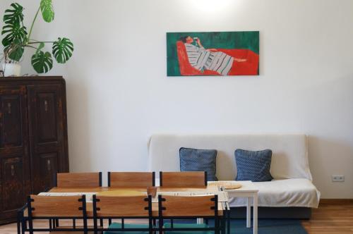 a living room with a couch and a table and chairs at Apartment Porta in Terezín