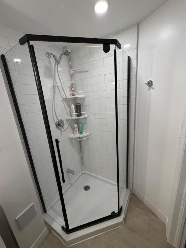a shower with a glass enclosure in a bathroom at Lovely apartment house in Grimsby