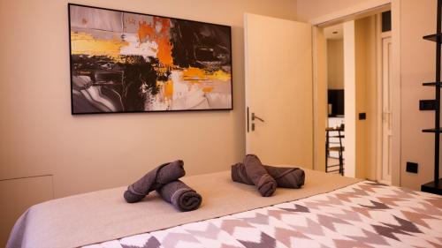 a bedroom with a bed with two pillows on it at Enzo's Apartments Prishtina in Prishtinë