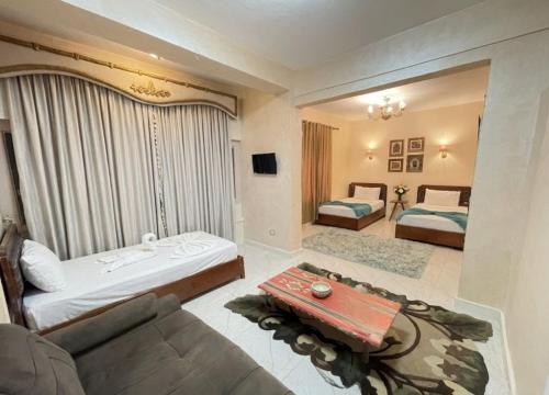 a living room with two beds and a couch at Le Caire Guest Houes Cairo in Cairo