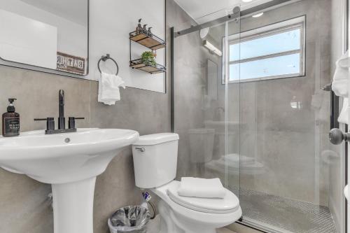 a bathroom with a toilet and a sink and a shower at Bayview Regency Apartments By Lowkl in Fort Lauderdale