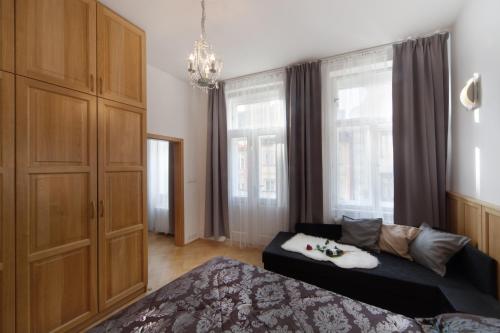 a bedroom with a bed and a large window at Old Town Melantrichova Apartment in Prague