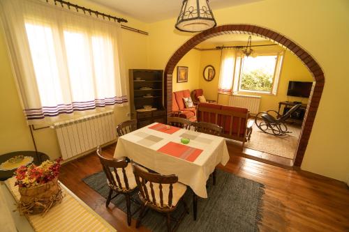 a dining room with a table and a living room at Smestaj Vanja in Arilje