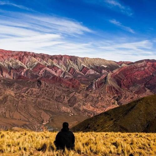 a man sitting on a hill looking at a canyon at Cómodo, bien ubicado y con host multilingüe in Montevideo