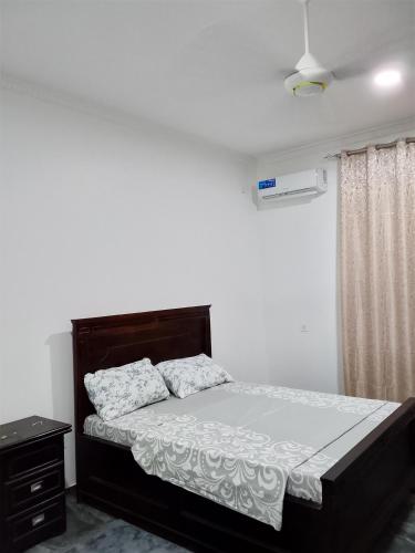 a bedroom with a bed and a dresser in it at Casa del Zanzibar in Zanzibar City