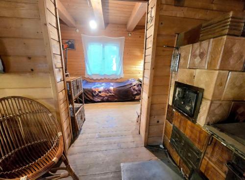 a room with a bed and a window in a cabin at Chata leśna u Górala in Stróża