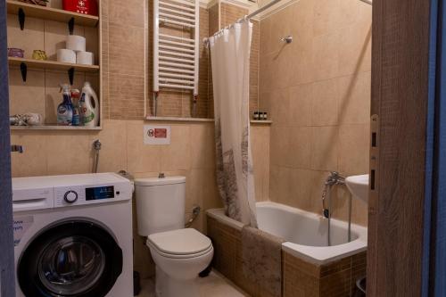 a bathroom with a toilet and a washing machine at Lanari Valley House in Thermi