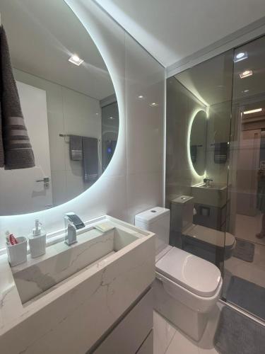 a bathroom with a toilet and a sink and a mirror at Charming Apartment in the Central Square in Bonito