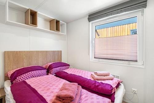 two beds in a room with purple blankets at Haus Lotte und Frieda in Riedenburg