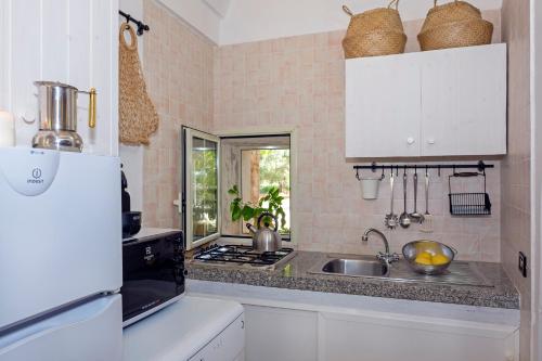 a kitchen with a sink and a counter top at Masseria Pagliamonte in San Vito dei Normanni