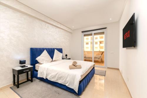 a bedroom with a bed with a teddy bear on it at Grand Standing 110m2 Piscine Terrasse Proche Plage in Agadir