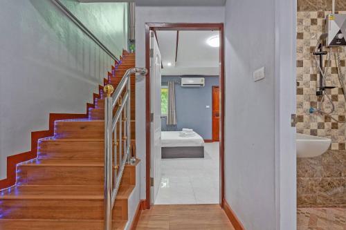 a bathroom with a staircase with a sink and a toilet at Large Spacious 3BR House at BTS ON NUT in Phra Khanong
