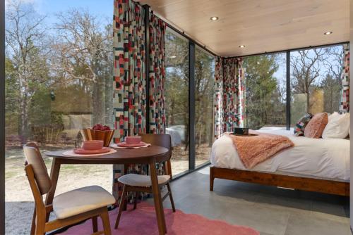 a bedroom with a bed and a table and chairs at Mod Squad in Saint Jo