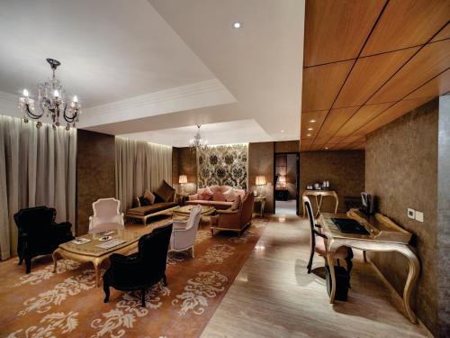 a living room with a couch and a table at Orange Megastructure LLP in Surat