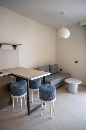 a living room with a table and chairs and a couch at Lorraine's Boutique Suites in Lourdata