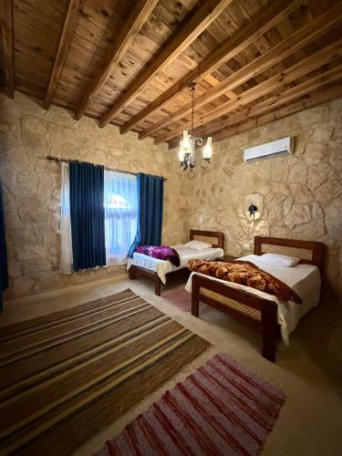 a bedroom with two beds and a large window at Tunis Village,lake view countryside villas in Tunis