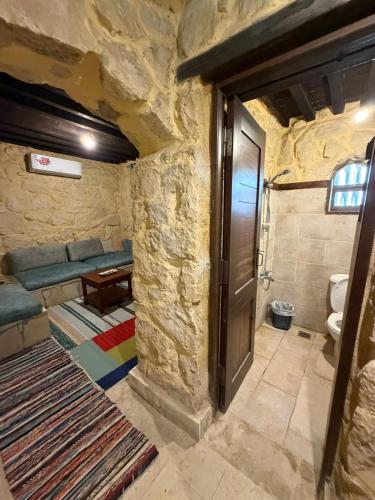 a stone room with a door and a room with a couch at Tunis Village,lake view countryside villas in Tunis
