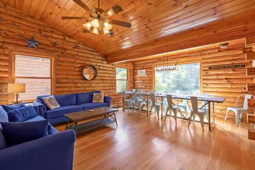 a living room with a blue couch and a table at Shimmering River Retreat in Edgecomb