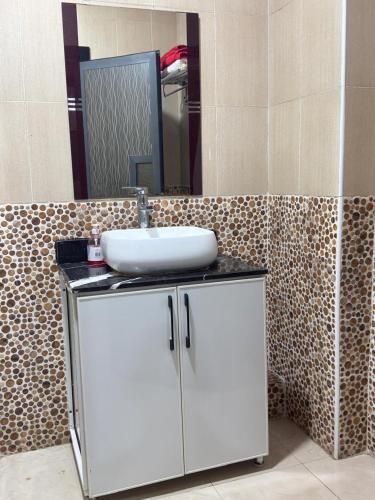 a bathroom with a sink and a mirror at corniche d or piscine ferme le lundi in Mohammedia