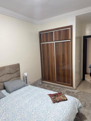 a bedroom with a bed and a large glass door at corniche d or piscine ferme le lundi in Mohammedia
