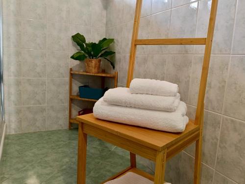 a stack of towels on a table in a bathroom at Casa Rina in Piano Conte
