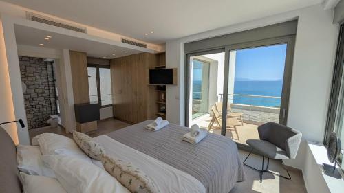 a bedroom with a large bed and a balcony at Villa Levanda in Kiveri