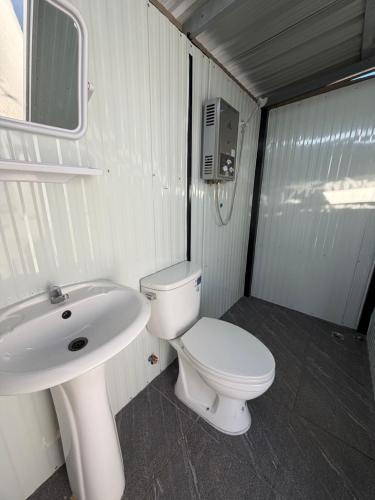 a small bathroom with a toilet and a sink at Heaven Khaokho (เฮฟเว่น) in Khao Kho