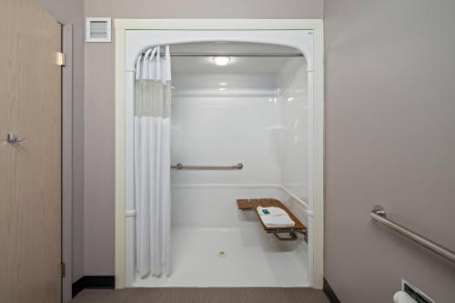a bathroom with a shower with a shower curtain at Prairie Crest Medicine Hat by IHG in Medicine Hat
