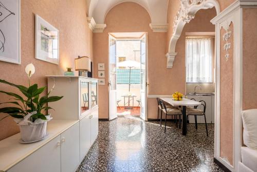 a kitchen with a sink and a table in a room at Old Town Bonbonniere in Bordighera