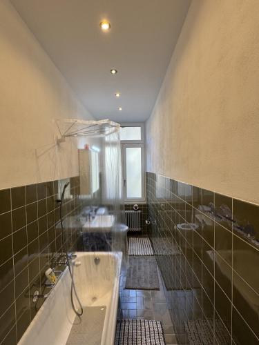 a large bathroom with a tub and two sinks at Apartment in Historic Villa in Faido