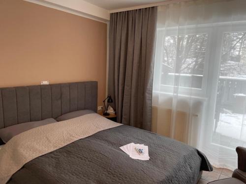 a bedroom with a bed and a large window at Innside - Terrace and Mountain Views in Innsbruck