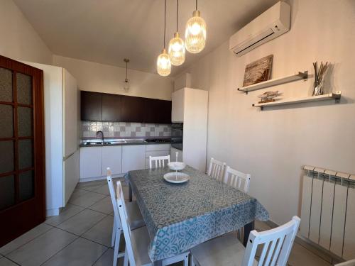 a kitchen and dining room with a table and chairs at Casa sole cuore amore in Torre del Lago Puccini