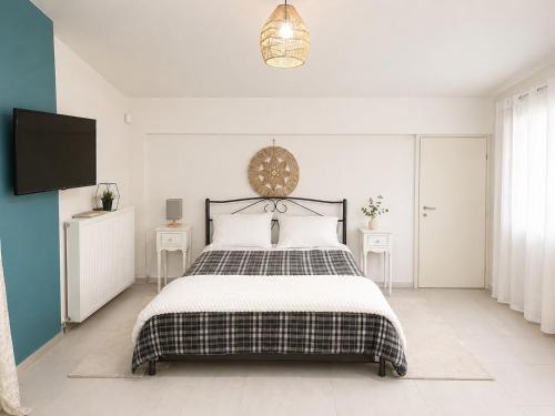 a bedroom with a bed and a flat screen tv at Panorama View in Kalamata