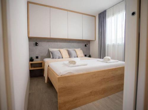 a bedroom with a large bed with white cabinets at Lux Mobile Homes Vodice in Vodice