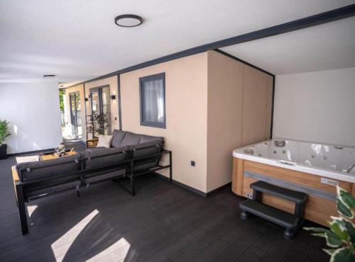 a large room with a tub and a couch at Lux Mobile Homes Vodice in Vodice
